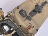 a close up of an old camera on a white surface