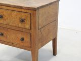 a small wooden table with three drawers on top of it