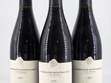 three bottles of wine sitting on top of a white table