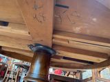 a close up of a wooden table with writing on it