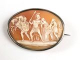 une photo d'une broche sur laquelle figure l'image d'un groupe de personnes