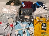 a lot of clothes that are sitting on a shelf