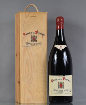 a bottle of wine in a wooden box next to a bottle of wine