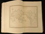an open book with a map of the world on it