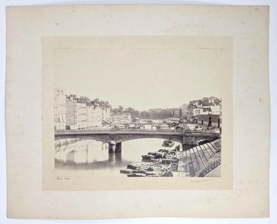 an old photo of a bridge over a body of water