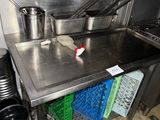 a stainless steel counter top with pots and pans on it