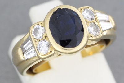 Bague en or ornée d’un saphir épaulé de brillants et de diam…
