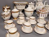 a lot of coffee cups and saucers on the table