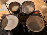 a close up of a drum set on a wooden floor