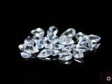 a close up of a bunch of diamonds on a black surface