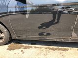 a shadow of a person on the side of a car