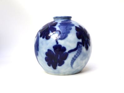 a blue and white vase sitting on a white surface