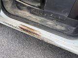 a car door with rust on the side of it