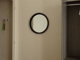 a mirror hanging on the wall in the hallway