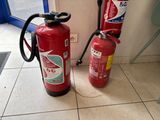 two fire extinguisors sitting on the floor next to each other