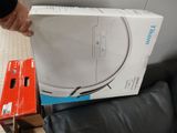 a person holding a box that is sitting on a couch