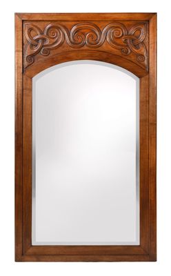 a large wooden mirror with a carved design on the front