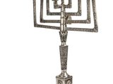 a silver plated menorah with four candles on a stand
