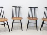 three wooden chairs sitting next to each other in a room