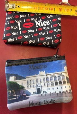 two purses with different designs on them on a table