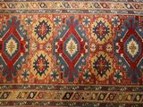 an antique persian rug with a red, blue, and yellow design