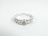 a close up of a diamond ring on a white surface