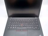 a black laptop with a red button on the keyboard