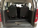 two seats in the back of a van with the door open