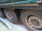 a green truck that is parked on the side of the road