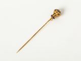 a gold stick with a black and white flower on it