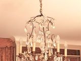 a chandelier hanging from the ceiling in a living room