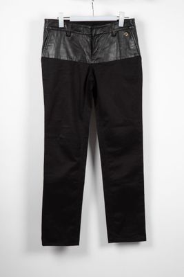 a pair of black pants hanging on a hanger
