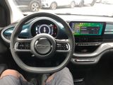 someone is sitting in the driver ' s seat of a car with their feet on the steering wheel