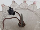 a small glass vase with a light on top of it