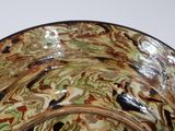 a close up of a bowl on a white surface