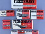 four boxes of fleischmann cigarettes on a blue surface