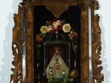 a picture of a small shrine with flowers in it