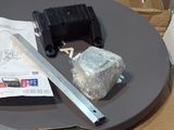 a knife and a rock on a table next to a piece of paper