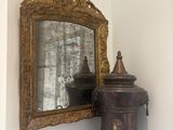 a mirror on the wall next to a wooden cabinet
