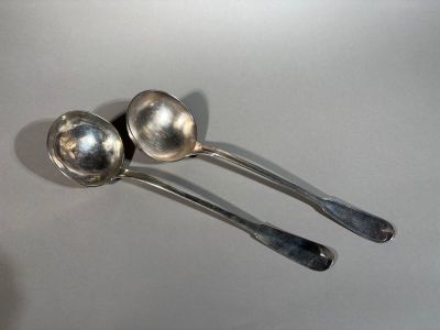 two spoons that are sitting on a table