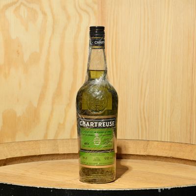 a bottle that is sitting on top of a barrel