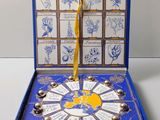 an open blue box with a clock inside of it on a table