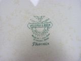 a close up of a plate with a bird on it