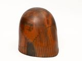 a wooden object that is sitting on a white surface