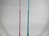 two different colored toothbrushes sitting on a white surface