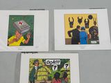 three comics are displayed on a table in a display case