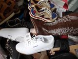 a pile of shoes and shoes that are on the floor