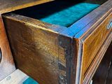 a wooden desk with a drawer on top of it
