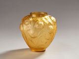 a yellow glass vase with a design on it