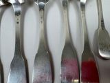 five spoons that are sitting on a table